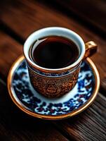 Elegant coffee cup with intricate design on a wooden table photo
