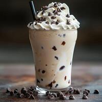 Creamy ice cream drink with whipped cream and chocolate chips served cold photo