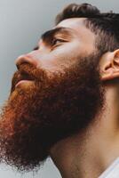 Muslim Man With a Red Beard in Natural Light on Gray Backdrop photo