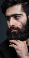 Muslim Man With Impressive Beard Posing Against Dark Background photo