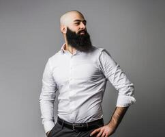 Muslim Man in White Shirt Posing With Hands on Hips Against Gray Background photo