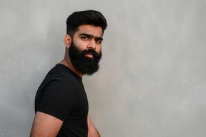 Muslim Man With Beautiful Beard Posing Against Neutral Background photo