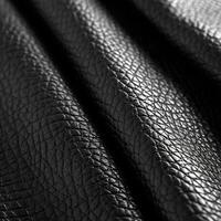 Close-Up of Black Leather Material Displaying Textured Surface photo