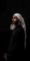 Man in Traditional Attire With Beard on Black Background photo