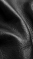 Close-Up of Textured Black Leather Material Draped Elegantly photo