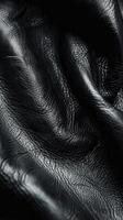 Black Leather Material Draped Elegantly on a Soft Fabric Surface photo