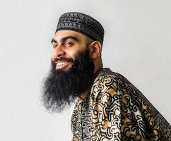 Muslim Man Smiling With a Beautiful Beard in Traditional Attire photo