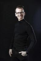Smiling Male Executive in Minimalistic Setting Against Dark Background photo