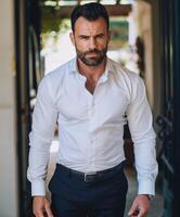Confident Man in White Shirt Walking Through Elegant Archway photo