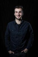 Minimalistic Portrait of a Smiling Male Executive in a Dark Setting photo