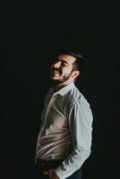 Smiling Male Executive in Minimalistic Portrait Against Dark Background photo