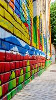 Vibrant Street Art Displayed on a Colorful Brick Wall in Urban Alleyway photo