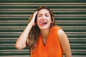 Woman flirting sticking the tongue out smiling at camera photo