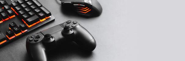 Horizontal banner of a keyboard and mouse for gamer together a joystick concept for online games. photo