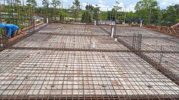 Construction worker pours concrete on the concrete floor of a building at a construction site photo