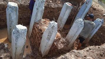 Concrete piles foundation under ground for a new building on construction site. photo
