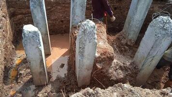 Concrete piles foundation under ground for a new building on construction site. photo