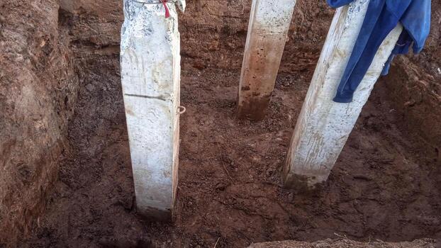 Concrete piles foundation under ground for a new building on construction site. photo