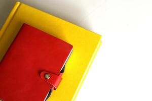Stack of yellow and red books isolated on white background with copy space area photo