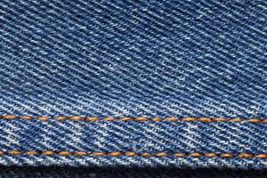 Blue jean texture. Blank denim cloth textile background. Soft fabric. Flat cotton surface. Grunge structure design. Dark navy material. Indigo vintage style. Copyspace photo