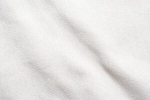 A soft, pure white fabric background with a delicate grid pattern. The texture is smooth and plain, resembling linen or cotton. Light creates subtle shadows on the surface. photo