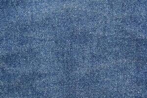Blue jean texture. Blank denim cloth textile background. Soft fabric. Flat cotton surface. Grunge structure design. Dark navy material. Indigo vintage style. Copyspace photo