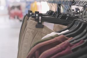 trouser hanging in clothing store photo