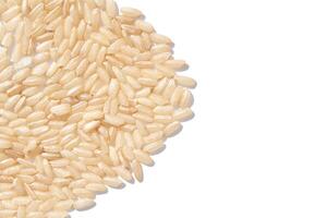 A background of dry brown rice grains showcases the integral, uncooked basmati texture. The macro view highlights the raw nature of this organic, whole food. photo