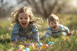 A boy and a girl smile while playing with Easter eggs in the grass photo