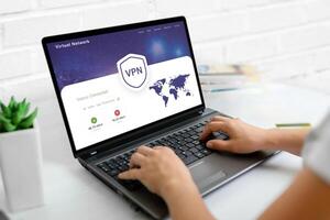 Using a VPN on a laptop. Web page concept with VPN connection and world map, emphasizing global online security and privacy photo