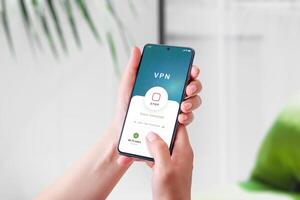Using a VPN connection app on a smartphone. Highlights mobile security, privacy protection, and secure internet access in a modern digital concept photo