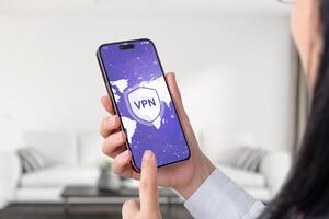 Woman holding a smartphone with a VPN connection, showing a world map on the screen. Emphasizes global online security and privacy photo