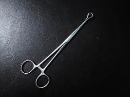 Allis Tissue Forceps, Surgical Instrument Isolated on the black Background photo