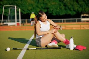 girl hockey player plays field hockey on a sunny day, a hockey player was injured in a game of field hockey, sports injuries photo