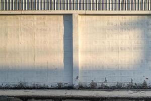 the empty clean and clear copy sapce Concrete brick block wall with the light and shadow shade on it. photo
