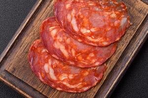 Delicious smoked meat sliced with salt, spices and herbs photo