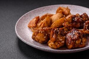 Delicious crispy baked chicken wings in teriyaki sauce photo