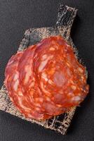 Delicious smoked meat sliced with salt, spices and herbs photo