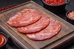 Delicious smoked meat sliced with salt, spices and herbs photo