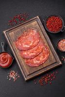 Delicious smoked meat sliced with salt, spices and herbs photo