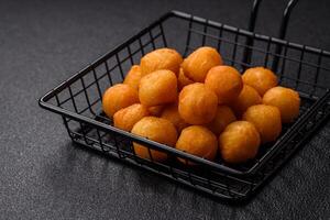 Cheese or potato balls breaded with salt, spices and herbs photo