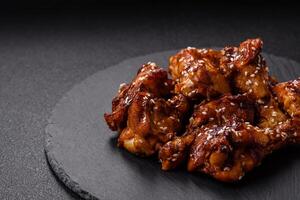 Delicious crispy baked chicken wings in teriyaki sauce photo