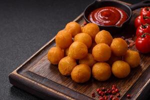 Cheese or potato balls breaded with salt, spices and herbs photo