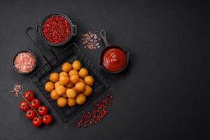 Cheese or potato balls breaded with salt, spices and herbs photo