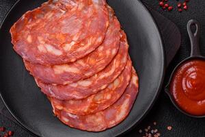 Delicious smoked meat sliced with salt, spices and herbs photo
