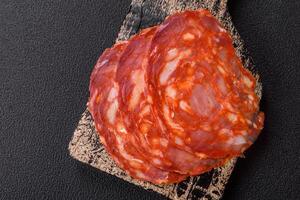 Delicious smoked meat sliced with salt, spices and herbs photo