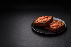 Sandwich or bruschetta with toast, salmon, cream cheese photo