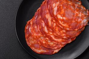 Delicious smoked meat sliced with salt, spices and herbs photo