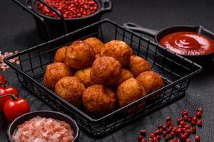 Delicious crispy balls breaded with mozzarella cheese, salt and spices photo