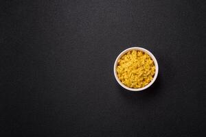 Delicious boiled yellow rice with turmeric, salt and spices photo